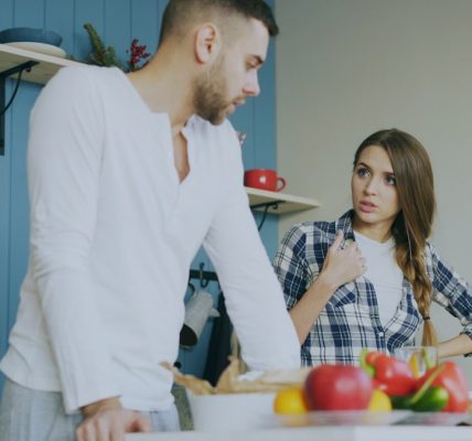 Young couple quarrels in the kitchen during breakfast time in the morning at home