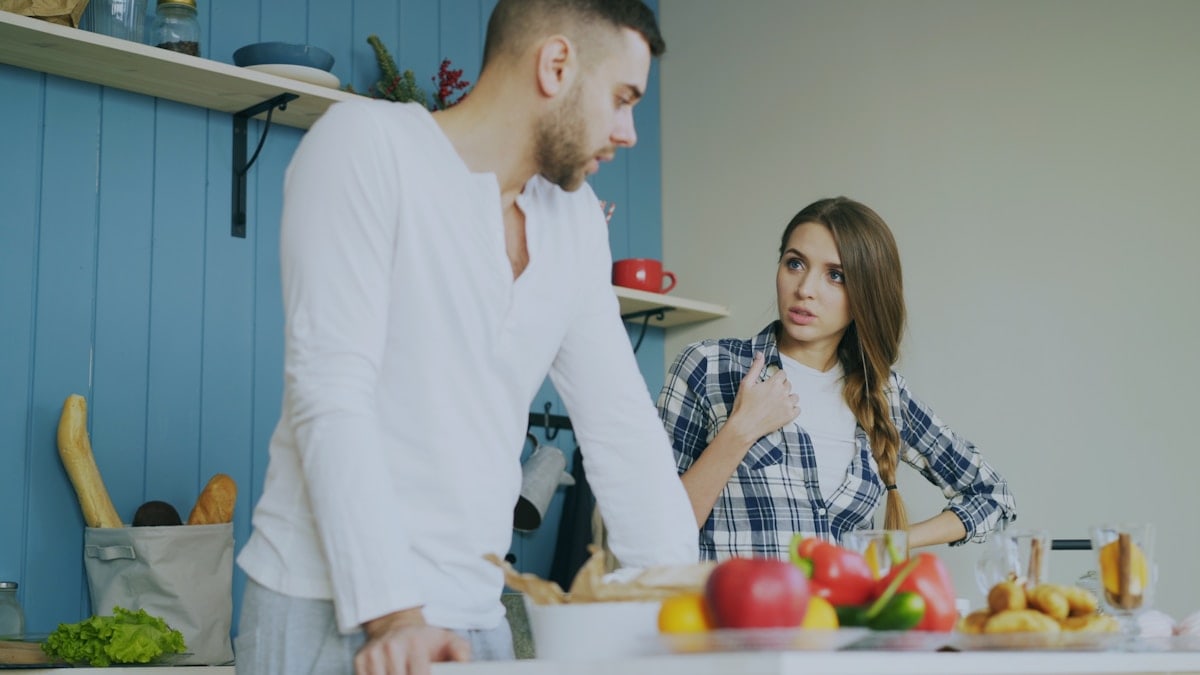 Young couple quarrels in the kitchen during breakfast time in the morning at home
